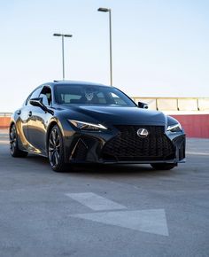 a black sports car parked in a parking lot