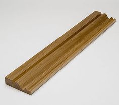 a piece of wood sitting on top of a white table