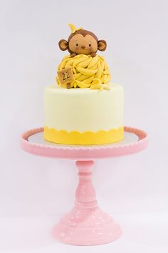 there is a small cake with a monkey on top