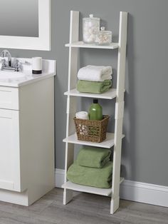 a white shelf with towels and other items on it