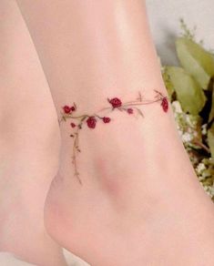 a close up of a person's foot with flowers on the bottom and one leg