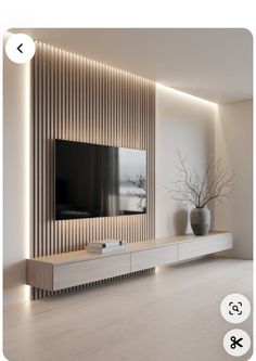 a tv is mounted on the wall in a room with white walls and wood flooring