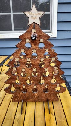 a wooden christmas tree with holes in it