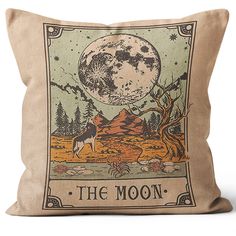 a pillow with an image of a wolf on the moon and trees in the background