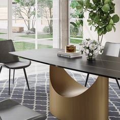 a dining room table with chairs and a potted plant