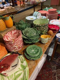 a table topped with lots of plates and bowls