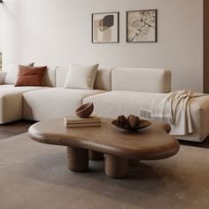 a living room with white couches and wooden table in front of large open window