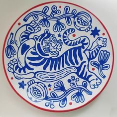 a blue and white plate with tiger designs on it