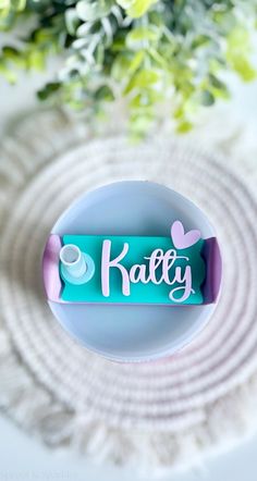 a white plate topped with a candy bar next to a green plant