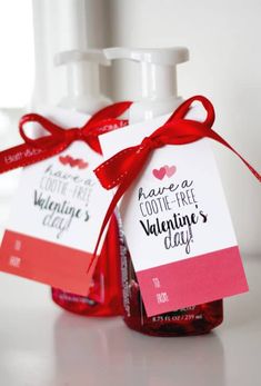 a bottle of valentine's day soap with a red ribbon tied around it