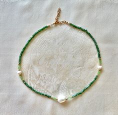 "Dainty ivy-green pearl necklace.                                     🌿✨                                                                                   Mixture of metal, glass and pearl beads.                    Light green beads are Swarovski. Dark green beads are sparkly cubes. Necklace measures 16\" plus extender chain.            Metal is gold colored brass and steel.                       🌿✨                                                                                  To prevent dis Green Pearl Necklace With Faceted Round Beads, Green Faceted Beads Pearl Necklace For Gift, Green Pearl Necklace With Beaded Chain For Gifts, Green Pearl Jewelry With Tiny Beads, Adjustable Green Pearl Necklace, Ivy Necklace, Necklace With Pearls, Green Beaded Necklace, Green Pearls