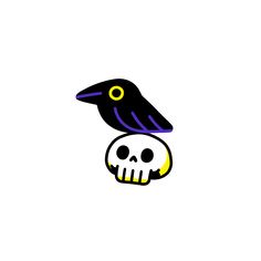 a black bird sitting on top of a skull