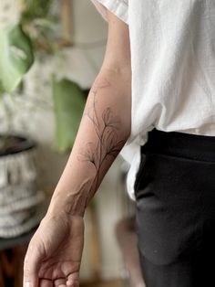 a person with a flower tattoo on their arm