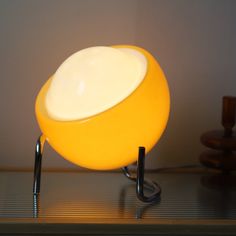 a yellow lamp sitting on top of a wooden table