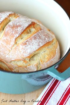 a loaf of bread sitting in a blue pot