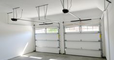 an empty garage with three overhead lights