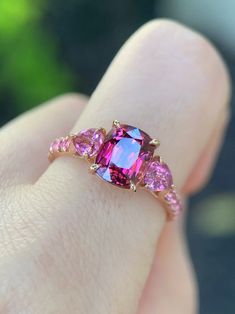 Sweet Pink Heart Shaped Tourmaline Ring Purple Pink Tourmaline | Etsy Purple Cute Things, Pink Three-stone Sapphire Jewelry, Pink Sapphire Three Stone Jewelry, Pink Sapphire Three-stone Jewelry, Pink Lab-created Ruby Gemstone Jewelry, Hot Pink Engagement Ring, Pink Ruby Gemstone Ring For Anniversary, Pink Ruby Ring With Accent Stones For Promise, Pink Heart Cut Fine Jewelry Ring