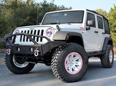 a white jeep is parked on the street