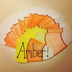 an orange and white paper turkey with the word amber written on it