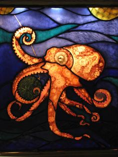 an octopus is depicted in this stained glass window