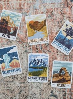 four stickers with the name grand canyon are on a table next to an old rug