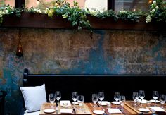 an outdoor dining area with wooden tables and chairs