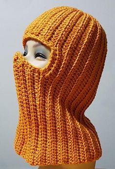 an orange knitted hood on top of a mannequin's dummy head