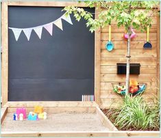 an outdoor play area with sand and toys