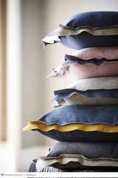 a stack of pillows sitting on top of a table