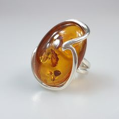 Amber ring. Brown cognac Amber. Certificated Sterling silver 925. Big nice stunning ring. Adjustable size. Oval shape. weight 11,40 gr Stone size- 3,1 x 2,2 cm This item was made of natural Baltic Amber. All the amber used in my jewelry is collected in my home country Lithuania. I sell only genuine, real, not pressed, authentic, natural Baltic Amber. Item may have natural imperfections. Baltic Amber Jewelry, Amber Gemstone, Amber Ring, Jewellery Uk, Amber Stone, Amber Jewelry, Elegant Ring, Baltic Amber, Ring For Women