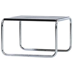 a metal side table with a black top and chrome frame on the bottom, against a white background