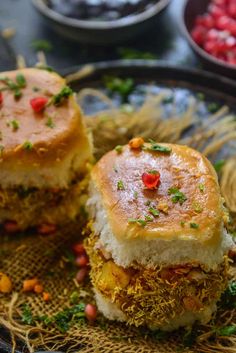 two pieces of food sitting on top of a cloth covered plate with garnishes