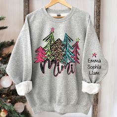 Mimi Bright And Leopard Christmas Trees, Custom Mimi And Kids TH Sweatshirt Suitable for many occasions such as Christmas, Father's Day, Mother's Day, birthday This classic crew-neck sweatshirt is an essential basic item for anyone’s wardrobe. The ribbed cuffs on the sleeves and waist are reinforced, and the high-quality cotton ensure that anyone will enjoy this cuddly and cool sweatshirt for many moons to come. Preshrunk fleece knit Double-needle stitching at shoulder, armhole, neck, waistband Gifts For Gigi, Leopard Christmas, Grandma Sweatshirt, Grandma Sweater, Leopard Shirt, Trees Christmas, Grandma Gift, Sweatshirt Christmas, Embroidered Sweatshirt