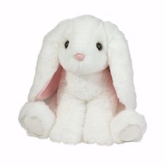 a white stuffed rabbit sitting up against a white background