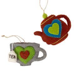 two felt teapot ornament hanging from strings on a white background, one with a heart and the other with an i love tea bag