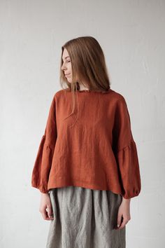 Tunic is made from 100% soft and washed linen. Match it with our skirts! Details: - Composition: 100% Oeko-Tex certified linen - Colour: rust - Ruffle neckline - Dropped shoulders - Size: One size/fits all - Medium weight linen - Linen care: machine wash gentle; tumble dry low, ironing optional - The price is for one tunic, other pictured items are not included Measurements: Length from shoulder down: 55 cm (21,66 in) Chest width: 140 cm (55,1 in) Sleeve length (from collar): 60 cm (23,6 in) Bot Rust Blouse Outfit, Linen Lagenlook Blouse For Fall, Fall Lagenlook Linen Tops, Oversized Long Sleeve Ramie Tops, Oversized Bohemian Linen Tops, Flax Relaxed Fit Top For Fall, Fall Linen Tunic Blouse, Simple Top Pattern, Linen Shirt Outfit