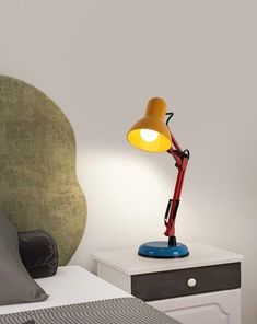 a lamp on a nightstand next to a bed