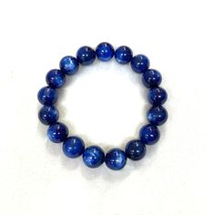 Kyanite Gemstone Japanese Juzu Bracelet Characteristics of the product Material : Kyanite, Silk elastic cordWrist size : 17～18cm/6.7～7.1in (Stretch) ※The number of beads may be different from the picture. (depends on the product) We adjust the size to your wrist for a fee.Main beads : about 12mm Handmade in Kyoto, JAPAN About kyanite Kyanite is an excellent stone for meditation, aligning all chakras and soothing your body instantly. It provides balance of yin-yang energy and dispels any blockage, moving energy gently through the physical body. Blue Kyanite opens the throat chakra, encouraging communication and self-expression. It helps you face fears and speak the truth. It is very useful for public speakers and performers as it strengthens the voice and heals the throat and the larynx. It Moving Energy, Kyanite Bracelet, Kumihimo Bracelets, Yang Energy, Amber Bracelet, Public Speaker, Blue Kyanite, Kyoto Japan, Throat Chakra