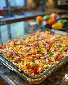 a casserole dish with ham, cheese and vegetables in it on a kitchen counter