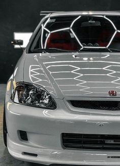 the front end of a silver sports car