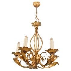 a gold chandelier with five lights hanging from it's center and leaves on the bottom