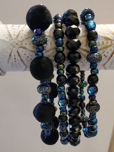 Unique bracelet stack, no one else will have one like this, cute flocked black beads, mixed with purplish beads, black crystal beads. These are a stretchy set, 4 bracelets. Approximately 7 inches. Will look great worn together or separately. Get ready for ooos and ahhs when you wear this stack. Cheap Multicolor Beaded Bracelets With Black Beads, Black Spiritual Bracelets For Party, Black Bohemian Beaded Bracelets With Faceted Beads, Bohemian Black Beaded Bracelets With Faceted Beads, Black Faceted Beads Crystal Bracelet For Party, Bohemian Black Crystal Bracelet With 8mm Beads, Black Crystal Bracelet With Faceted Beads For Party, Bohemian Black Beaded Bracelet With Faceted Beads, Large Black Beads For Party