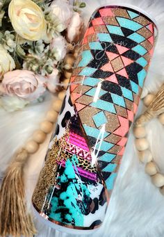 a colorful vase sitting on top of a white fur covered floor