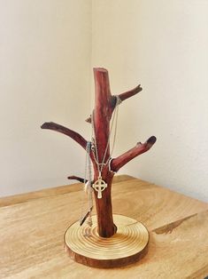 a piece of wood with chains hanging from it's sides on a wooden table