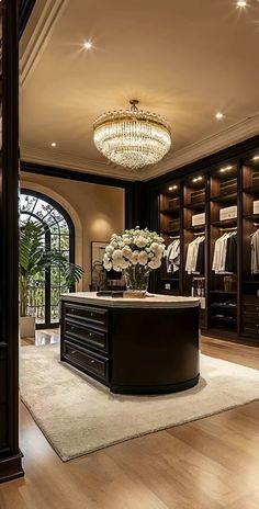 an elegant walk in closet with chandelier