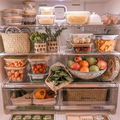 an open refrigerator filled with lots of different types of fruits and veggies in baskets