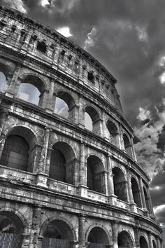 black and white photograph of the colossion in rome, italy with dramatic clouds