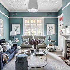 a living room with blue walls and furniture