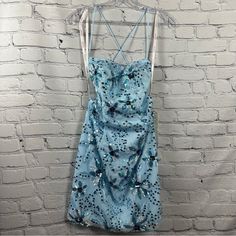 Promgirl Rated Pg Backless Sequin Short Prom Dress Floral Ice Blue 6 Nwt Sophisticated And Sparkly, This Short Prom Dress By Promgirl Has A Beautiful Sequin Floral Print That Is Sure To Steal The Show. In Ice Blue, This Short Sequin Party Dress Is A Favorite For Prom, Wedding Receptions, And Other Semi-Formal Events. The Curve-Hugging Short Blue Designer Dress Has A Sheer Overlay That Shines With Gorgeous Sequin Flowers From The Slightly Curved Neckline To The Hem Of The Fitted Skirt. Thin Shoul Blue Designer Dress, Short Dance Dresses, Prom Dress Floral, Corset Details, Zipper Corset, Sequin Flowers, Floral Ice, Semi Dresses, Curved Neckline