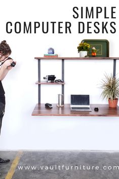 a woman standing in front of a computer desk